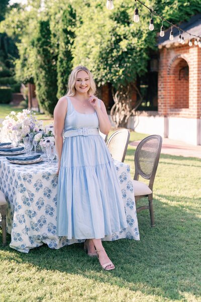 a woman in a blue dress at table