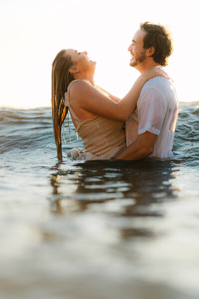 couple in the water during golden hour
