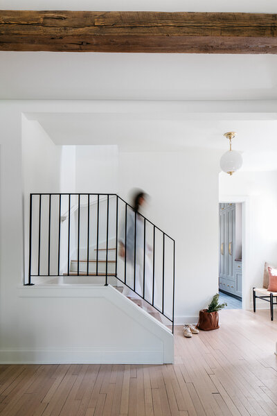 blurry woman walks down stairs