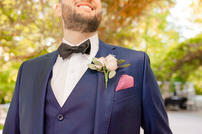 Gramercy Mansion Wedding Photographer snaps a photo of a groom under the wisteria of the Liriodendron Mansion gazebo