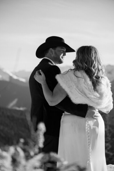 Photo of couple just after the conclusion of their wedding ceremony. The bride looks into the camera and smiles.