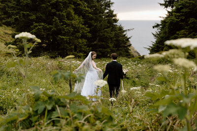 Couple walking among a meadow of flowers in Oregon.