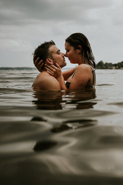Couple embracing each other face to face in the water