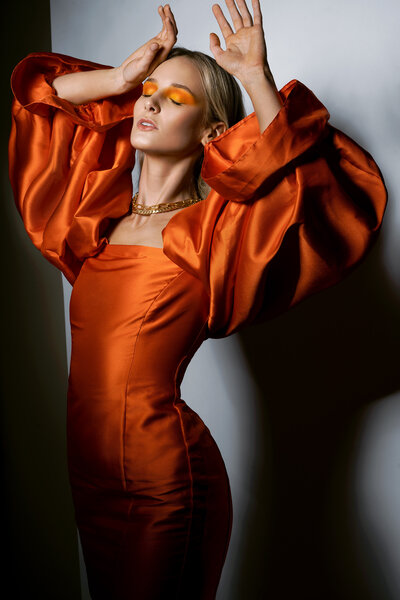 fashion shoot of model in orange dress