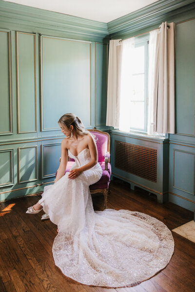 bride standing on a staircase holding a flower bouquet