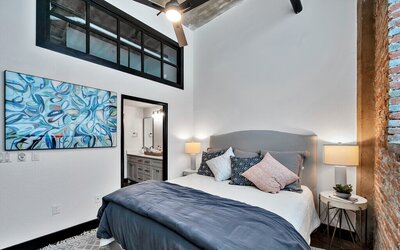 Bedroom with private bathroom in this three-bedroom, two-bathroom vacation rental condo in the historic Behrens building in downtown Waco, TX.