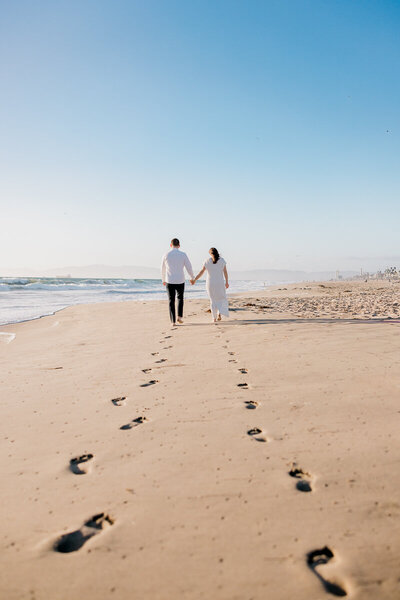 creative footprints in the sand shot during manhattan beach engagement photography session