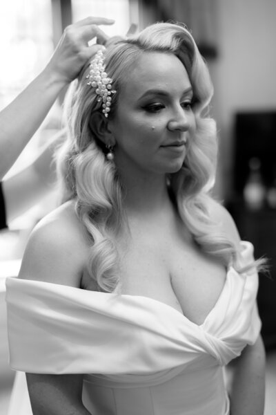 Real Bride Rosh's traditional hollywood wave hairstyle with hair comb accessory and veil at Lainston House