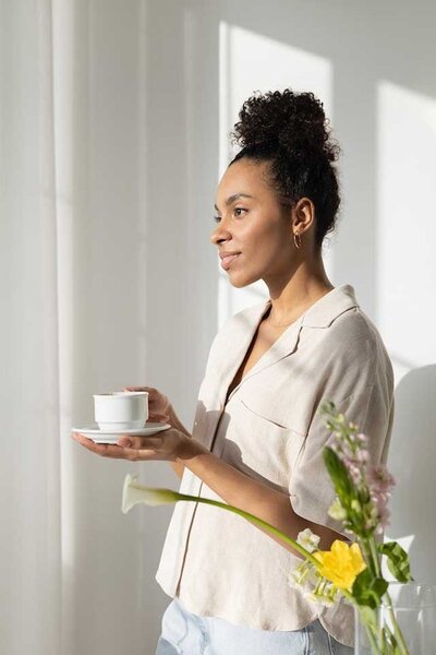 Young woman with cup and saucer