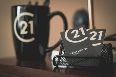 black coffee mug and black business cards sitting on a table