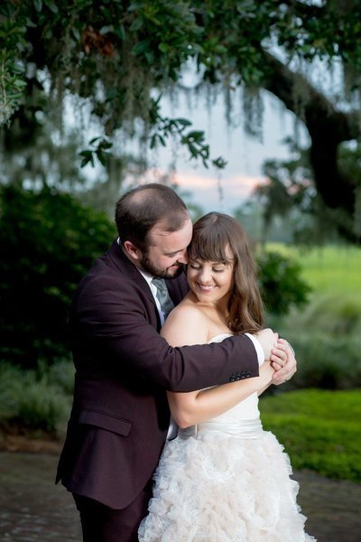 bride and grrom pose for a portrait at heritage plantation in pawleys island, south carolina