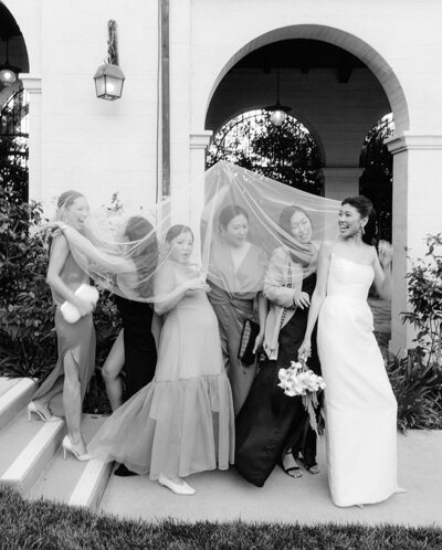 bride and bridesmaids having fun at the ebell of los angeles