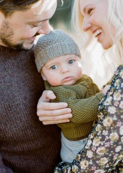 Family portrait of parents cuddling a baby, capturing intimate moments during a studio session at Pepper June in Castle Hill, Sydney's Hills District.