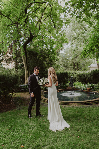 Bride and Groom share first look in outdoor garden