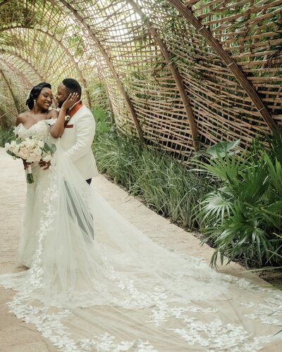 Nigerian wedding couple embraces under wood canopy