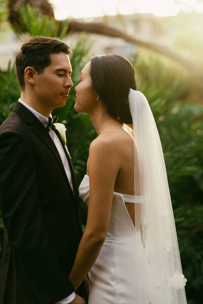 Multicultural ceremony under tropical florals at oceanfront Oahu venue