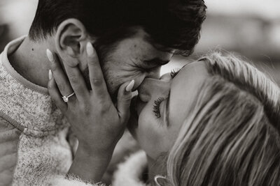 Close-up of couple smiling and touching foreheads, highlighting emotional connection during a Breckenridge engagement shoot.
