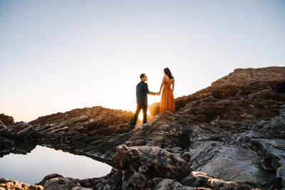 Beautiful sunset against Rocky formation beach engagement session