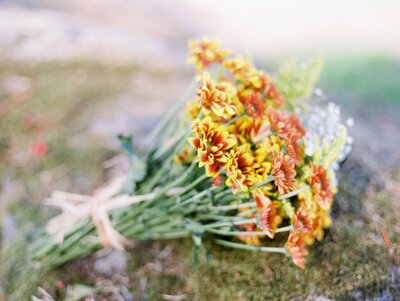 rustic engagement bouquet  of orange and yellow flowers