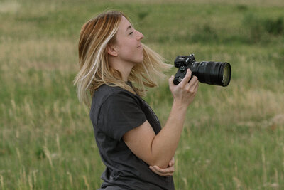 girl spinning and smiling while holding camera