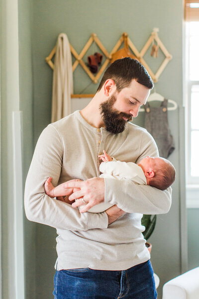 father holding baby