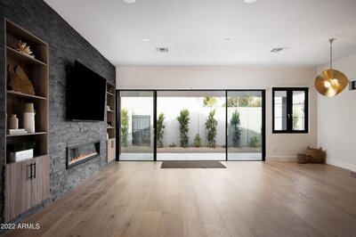 Double pane sliding glass patio door with a thick black casing that creates a modern style.