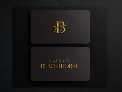 Business card mockup of a black card with gold logo