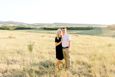 Couple standing in a field in Teton Idaho