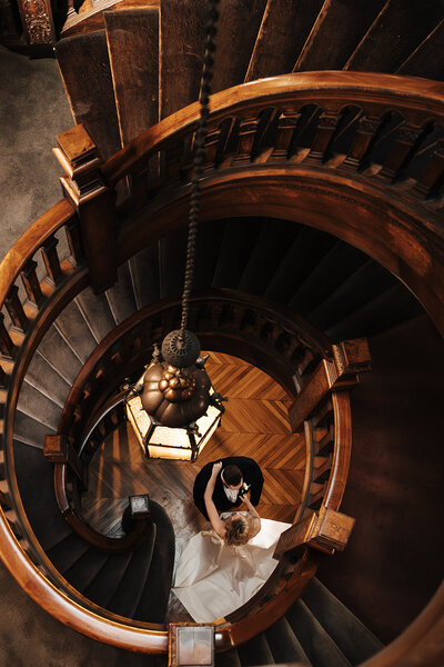 bride and groom posing near spiral staircase in philly for their wedding