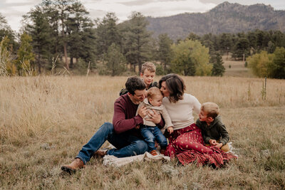 Parents swing their son during their Fort Collins Family Portrait PhotoSession