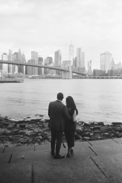 Black and white NYC engagement photos with Brooklyn Bridge in the background