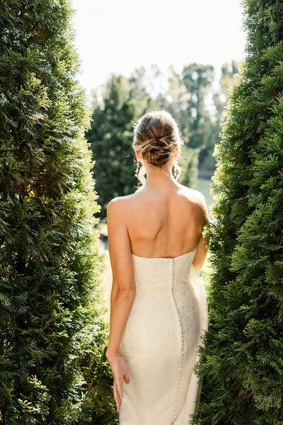 Bride with green eyes with a white veil being held by groom in black suit and black hair by Charlotte wedding photographer, Stephanie Bailey Photography.