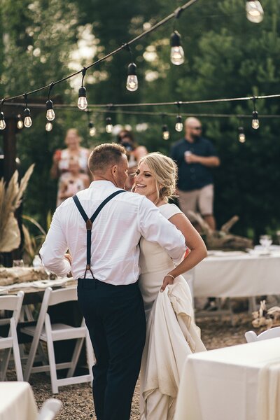 A couple celebrates their first dance before dinner and during their backard wedding.