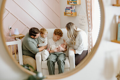 Mother holding up her newborn baby in hospital, photo taken by Indianapolis Newborn Photographer