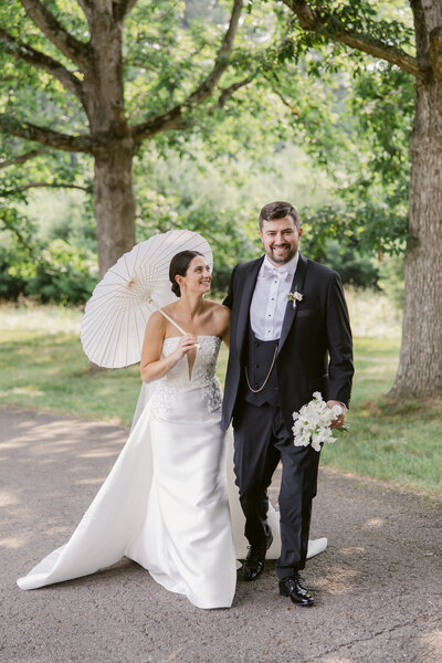 Newlyweds look at each other as they exit a building.
