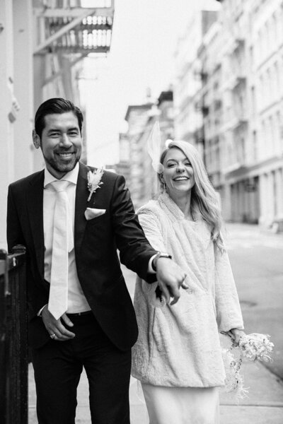 BRIDE AND GROOM IN FRONT OF CITY HALL