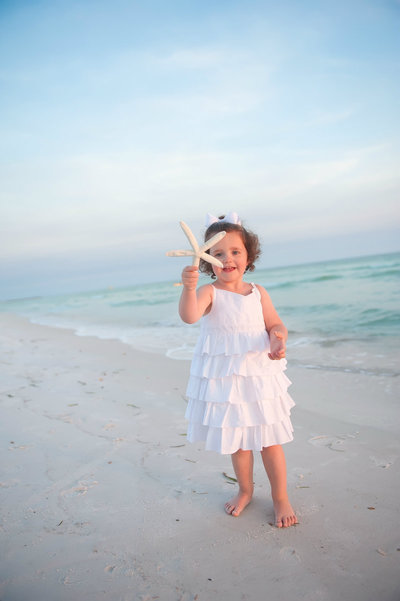 Little girl on Panama City Beach with a starfish