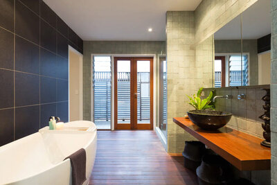 Bathroom with a bath, wash basin and glass french doors