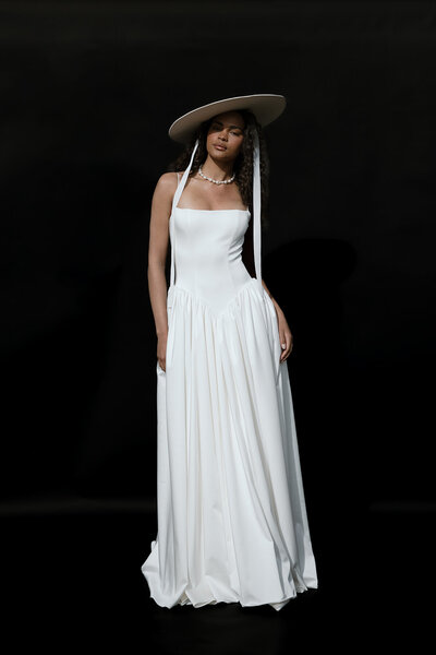 black and white image bride wearing strapless satin wedding dress with long train