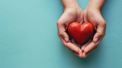 Open hands offering a red heart, representing emotional healing and sacred self-care

