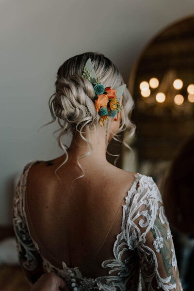 Bride with a side-parted low bun — chic, stylish bridal hairstyle created by Klover Beauty for Maryland weddings.