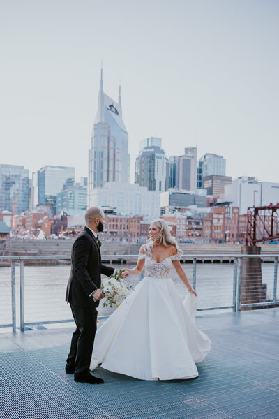 Destination wedding photographer captures couple dancing on the Cumberland Riverfront in Downtown Nashville wedding