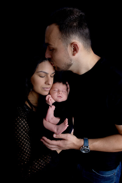 Newborn family black backdrop baby boy