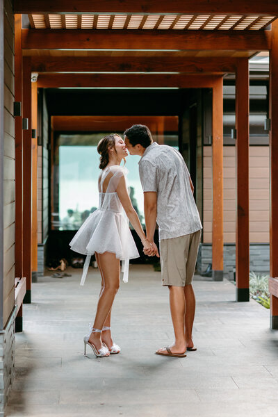 couple kissing next to ocean