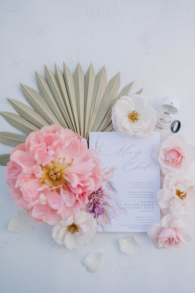 flowers laying on table surrounding white piece of paper