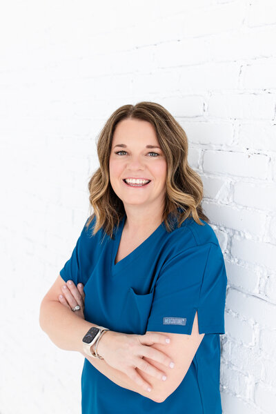 Meet the dedicated Women's Health Provider Team at Reforme Wellness, elegantly dressed in blue uniforms and standing in front of a white wall.