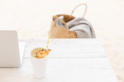 Close-up of a white ceramic cup filled with a frothy cappuccino, resting on a saucer with a small spoon, symbolizing a moment of focus, comfort, and inspiration