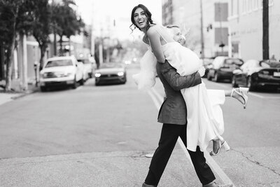 Groom carrying bride by Raleigh Wedding Photographer, Laura Memory