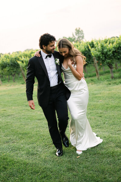 Couple walking together in love at sunset in vineyards at Kurtz Orchards in Niagara on the lake