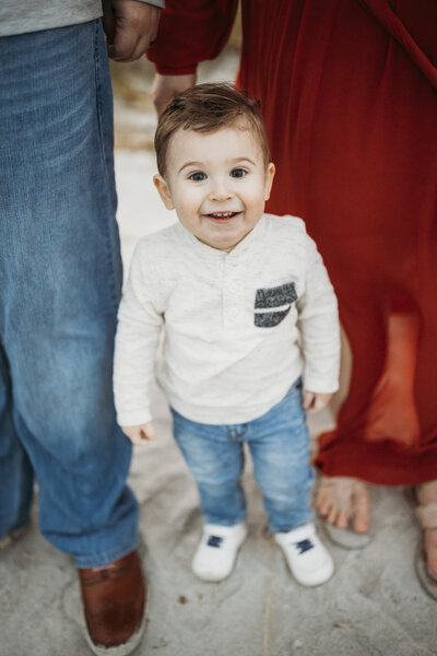 Baby Boy Sits on the Beach with Sand Dunes in the Background During a Ponte Vedre Beach Family Photo Session